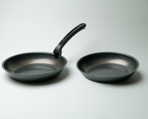 Two 10 inch carbon steel pans, one with the removable handle attached