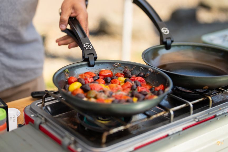 Carbon steel pan cooking tomatoe and olive dip