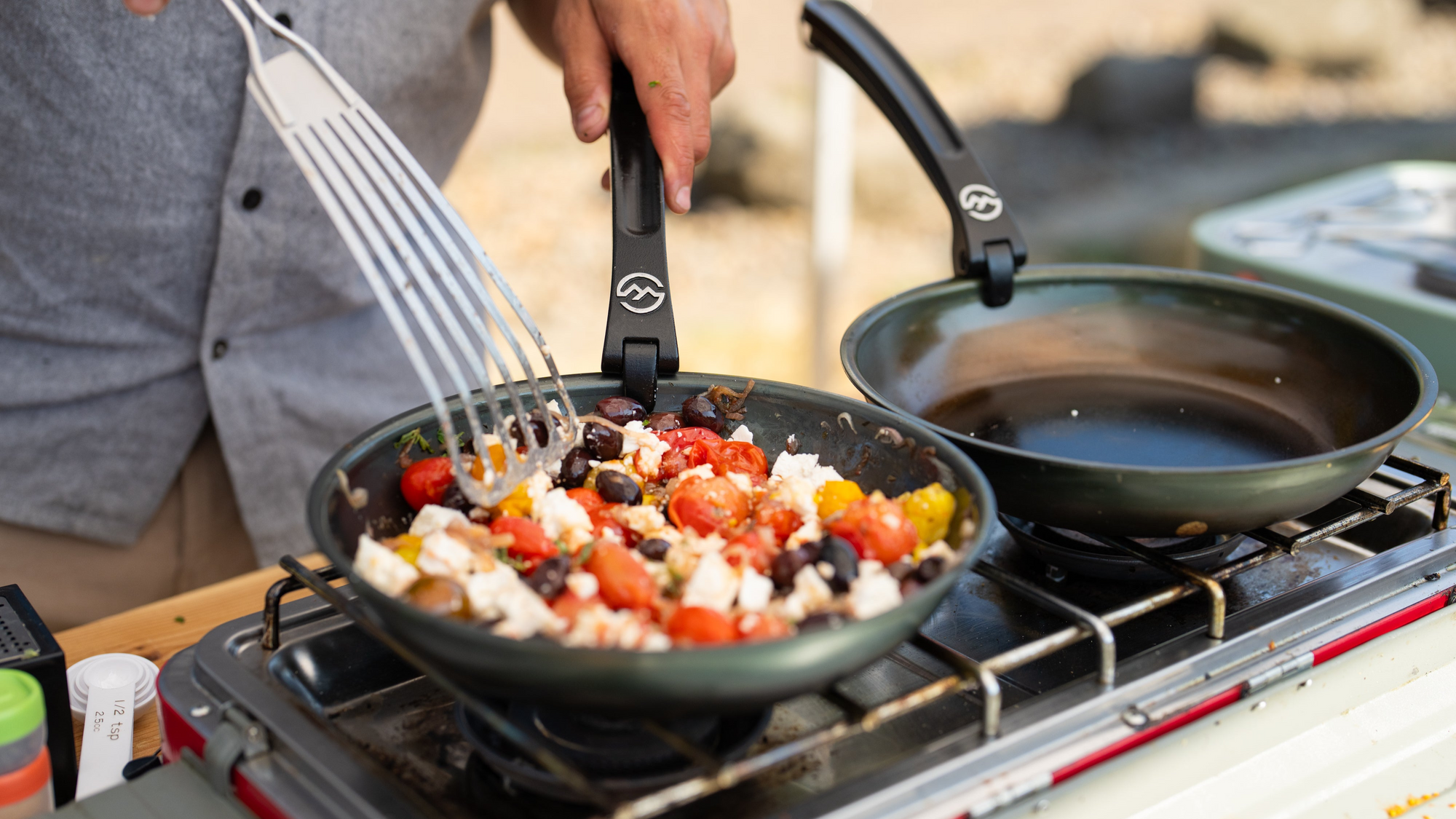 2 carbon steel camp cookware frying pans with delicious meal